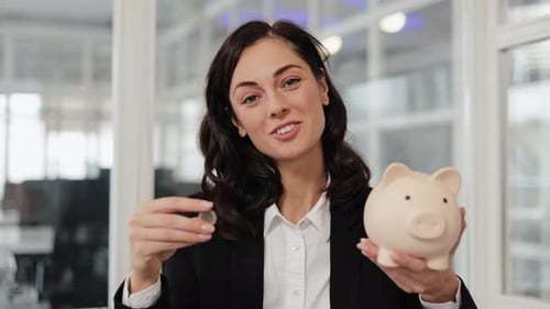 Businesswoman Happily Saves Money in Piggy Bank for Future Investments