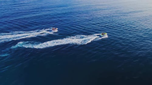 Jet Skis Speeding Across the Blue Ocean