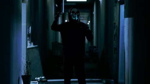 Hooded Figure with Skull Mask Holds Knife