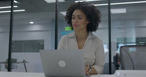 Businesswoman in Office Working on Laptop at Night