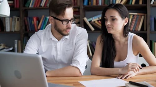 Creative students brainstorming ideas in trendy loft near books and desktop