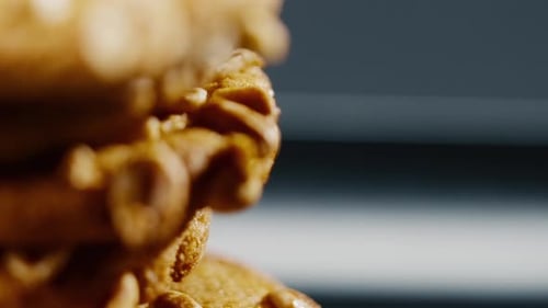 Close Up on Black and Blue Background Flat Plate with Cookie Cookies Built in a Pyramid Sweet