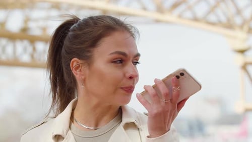 Woman Records Voice Message on Mobile Device