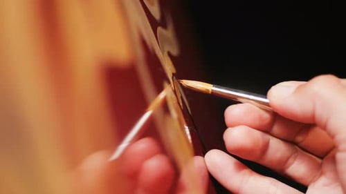 Close View Painter Makes Gold Drawings on Red Chiller Surface