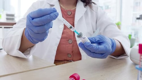 Covid vaccine, medical syringe and woman doctor hands in a hospital with laboratory medicine