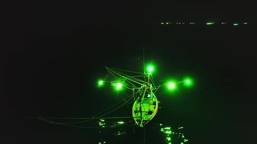 Fishing Boat Using Green Lights Illuminating the Sea at Night in Koh Phangan Thailand