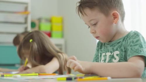 Children Drawing with Markers in Classroom Setting