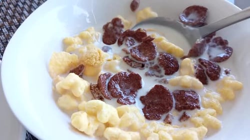 Colorful Cereal with Milk Being Stirred