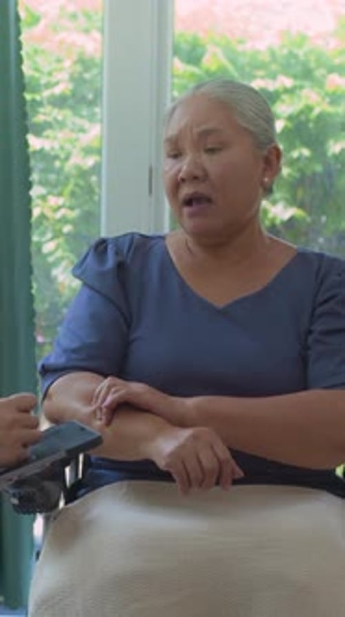 Senior Woman Talking with Tablet in Home Setting