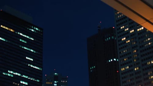 Low Angle Gliding Shot of Skyscrapers in the Tokyo. Financial District. Skyscape and Cityscape in t