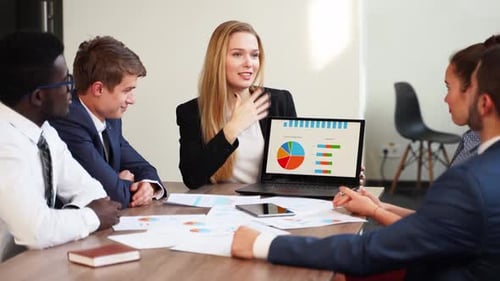 Colleagues Collaborate During Office Data Presentation