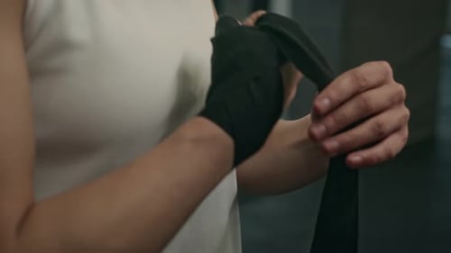 Young Adult Wrapping Hands in Gym