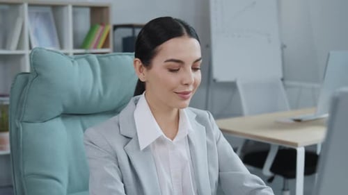 Portrait of Serious Business Woman Looking at Computer Screen in Office Female Manager Typing on