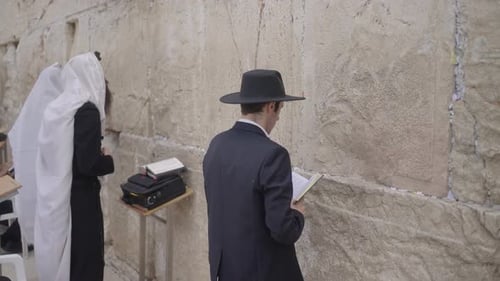 Jewish Prayer at Western Wall, Jerusalem, Israel. Religious men rock backwards and forwards and side