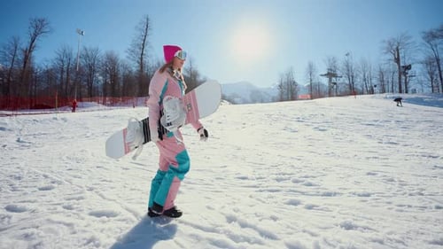 Woman Snowboarding at Sunny Winter Mountain Resort