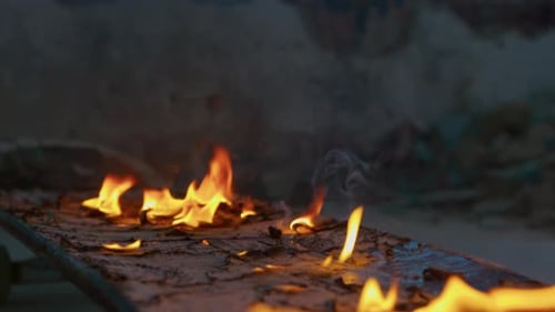 Burning Skateboard Deck Ablaze in Urban Setting
