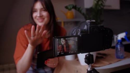 Young Woman Filming Video With Digital Camera