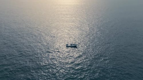 Luxury yacht sailing dark deep ocean at summer day aerial view