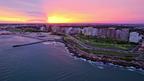 Aerial Pan Left of Ocean Shore Waterfront Mar Del Plata, Vibrant Scenic Sunset, Argentina