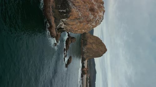 Vertical Aerial Shot of Haystack Rock Beach in Coastal Town Cannon Beach Oregon