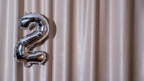 Stop Motion Happy New Year 2025 Metallic Balloons on Atlas Textile Background Greeting Card Silver