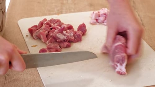 Dicing Raw Meat on Cutting Board for Cooking