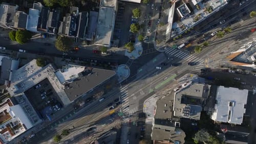 Top Down Descending Footage of Road Intersection in City Vehicles Driving in Streets and Standing in