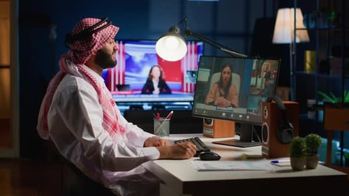 Man in Headscarf Attends Virtual Meeting
