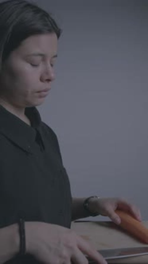 Vertical Close-Up of Woman Slicing Carrots with Precision