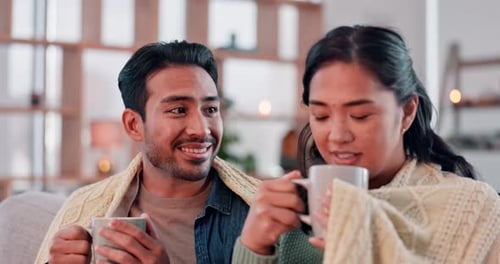 Smiling Couple Enjoying Warm Drinks at Home