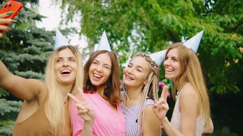 Smiling Women Celebrating and Taking Selfie Outdoors