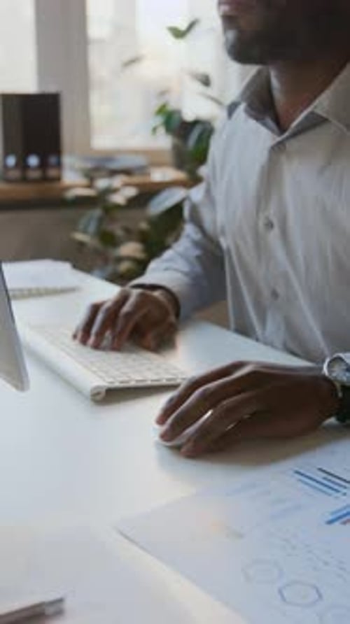 Black Male Manager Working on Presentation on Computer in Office