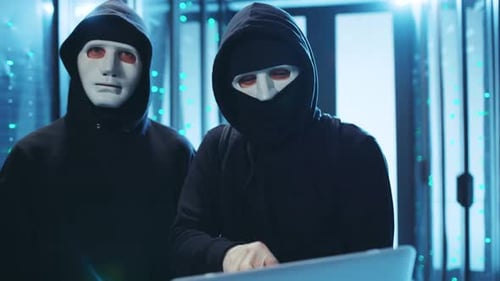 Hackers Coding Data Breach in Server Room
