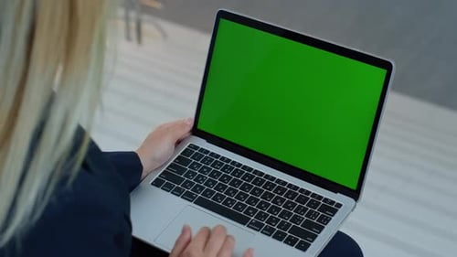 Woman Works on Laptop with Green Screen