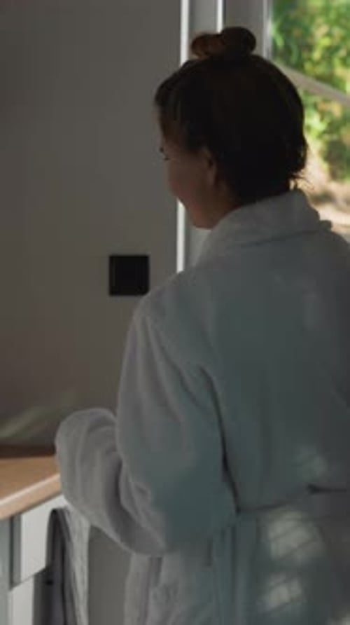Woman in Robe Making Coffee in Kitchen