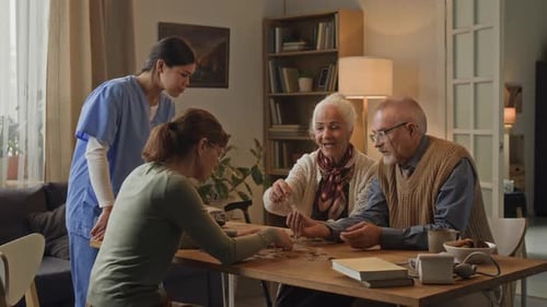 Seniors and Young Adults Doing Jigsaw Puzzle Together