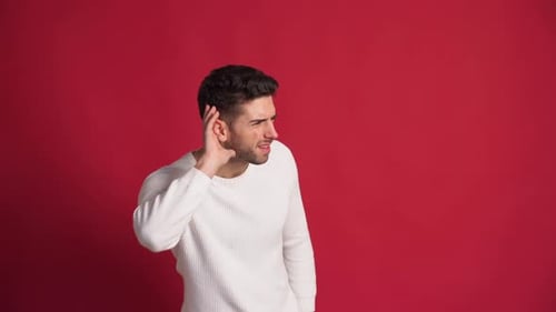 Man Cupping Ear and Listening Intently