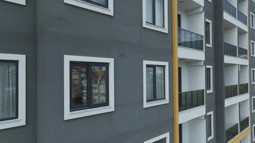 Aerial Video Aerial View of a Building Facade with Clouds Creating a Stunning Backdrop