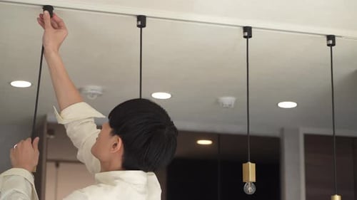 man installing lighting fixtures