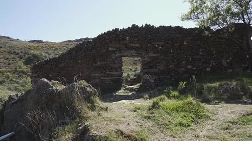 Large shoot of a door in a stone wall of ruins close to a medieval village