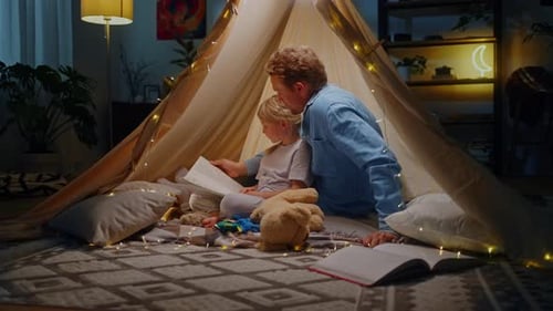 Father Reading to Daughter in Cozy Tent