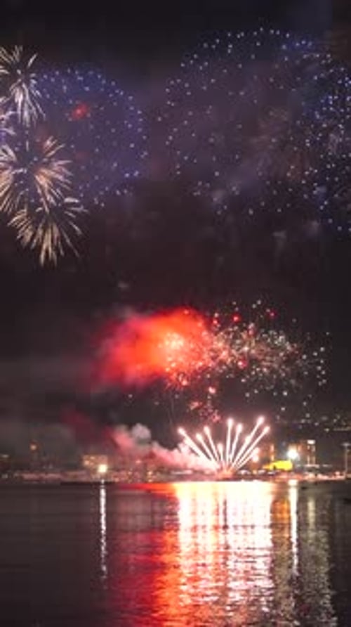 Fireworks with colorful lights over sea