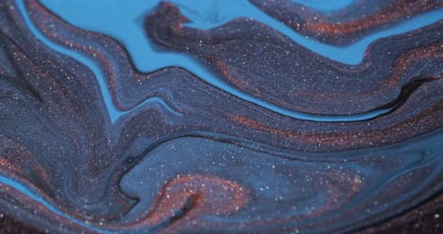 Swirling blue and bronze glitter paint background