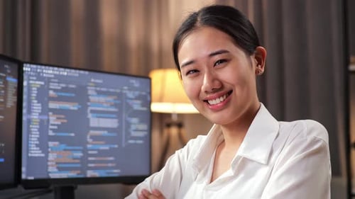 Nahaufnahme eines lächelnden und verschränkten Programmierers, während er eine App erstellt, die einen Softwareingenieur entwickelt