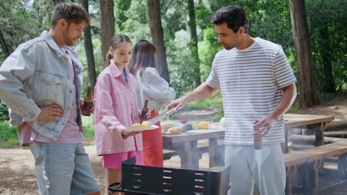 Friends Talking Summer Picnic in Green Forest Group Vacationers Grilling Food