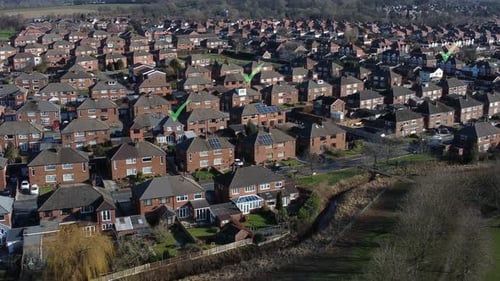 Multiple tick icons flashing above aerial view residential British neighbourhood property concept
