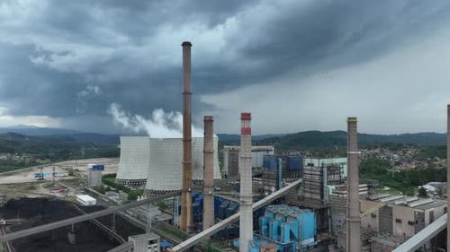 Aerial Drone Footage of a Large Coal Power Plant Station with Cooling Towers Chimney and Boiler