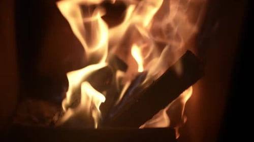 Close-up firewood burning with bright flames