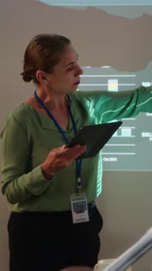 Vertical Video Business Partners Reviewing Monthly Data Reports in Night Time Meeting