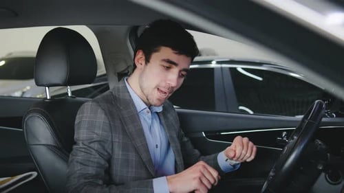 Man in Car Taps Fingers to Music Beat